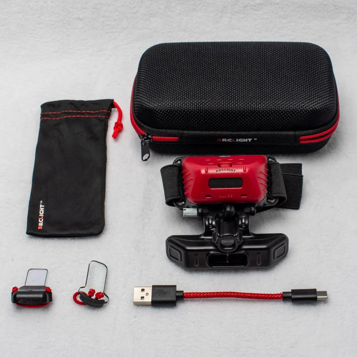 Arclight Holo kit including head loupe, carrying case, charging cable, lens clips, and storage pouch.